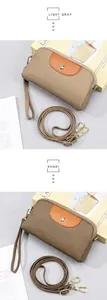 Detalle de bolsos bandolera de cuero auténtico en gris claro y caqui con grano de piel