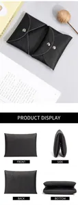 Macro detail of black pebble leather mini wallet showing multi-layered compartments and snaps