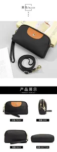 Detalle del bolso bandolera de cuero negro con parche marrón y remaches metálicos