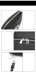Close-up of black lychee grain leather texture with silver dual metal zippers and strap hooks