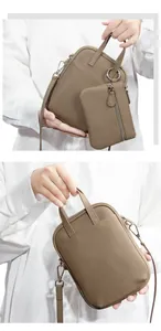Detail view of taupe lychee grain leather mini bag with silver hardware and pouch