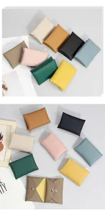Detailed view of genuine lychee leather coin purses in various colors with metal snap buttons
