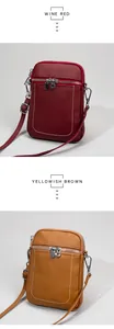 Close-up of wine red and yellowish brown leather crossbody phone bags with U-shaped stitching