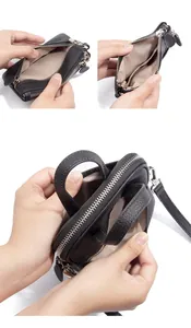 Close-up of black litchi grain leather phone bag showing interior card slots and zipper