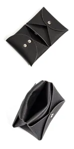 Detail of a black pebbled leather mini coin purse with snap closure and folded compartments