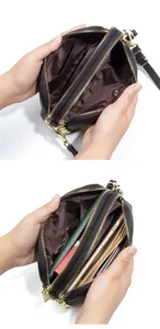 Detalle del bolso de piel con múltiples compartimentos con cremallera y herrajes dorados