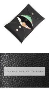Macro detail of black litchi grain cowhide leather coin purse with silver snap fasteners