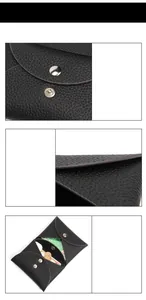 Detail of black pebbled leather mini wallet showing the snap closure and inner card slots