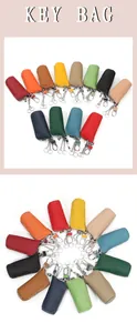 Macro view of genuine leather key bags in various colors with zippers and metal hooks