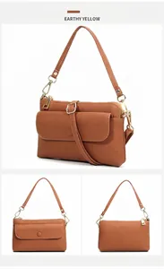 Sac bandoulière en cuir jaune terre avec texture grainée et détails de ferrures dorées