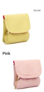 Detail view of mini pebbled leather coin purses in yellow and pink with gold chain straps