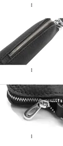 Close-up of black lychee grain leather texture and durable silver zipper on key case