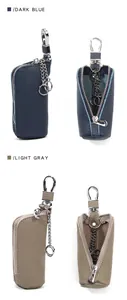 Detail of genuine leather car key pouch with smooth zipper and sturdy metal hook clasp