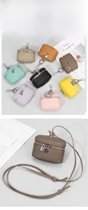 Detailed view of genuine leather mini coin purses in multiple colors with metal hardware