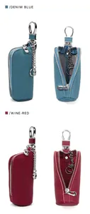 Detail view of denim blue and wine red leather car key pouches with zippers and hooks