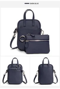 Detail of dark blue lychee grain leather crossbody bag with matching zipper coin pouch