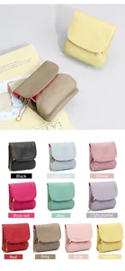 Detail of genuine leather coin purses with lychee texture and colorful stitching accents