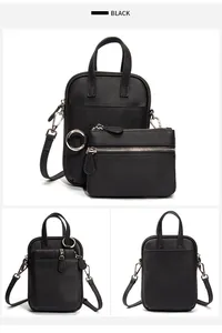 Macro view of black litchi grain cowhide bag set with silver hardware and small pouch