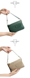 Close-up of leather phone bags in dark green and light gray with litchi grain texture