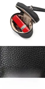 Macro detail of black litchi pattern top layer cowhide pouch and silver zipper