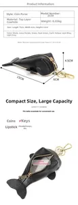 Detail view of whale-shaped leather key pouch with dimensions and internal storage