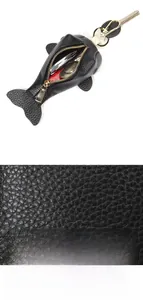 Close-up of litchi grain top layer cowhide on a black fish-shaped leather key pouch