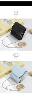 Detail of lychee pattern leather mini bags with colorful stitching and gold chain straps
