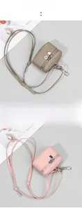 Detail of mini leather cross-body coin purses in elephant gray and sakura pink