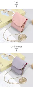 Detail of pink and purple mini leather purses with gold chains and pebble grain texture