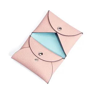 Pink and blue contrast leather coin purse with pebble texture and metal snap button