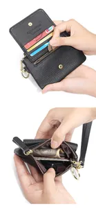 Detail of black pebbled leather wallet featuring multiple card slots and metal key ring