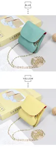 Detail of yellow and blue pebbled leather coin purses with gold chain straps