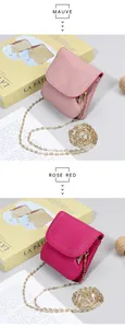 Detail of leather mini crossbody bags in Mauve and Rose Red with gold chain straps
