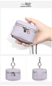 Close-up of Mambo Purple pebble grain leather mini pouch with silver zipper and spring clip