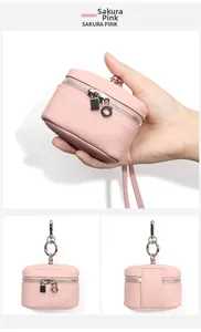 Detail of Sakura Pink leather mini coin purse with lychee texture and silver zipper hardware