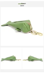 Macro detail of fish-shaped green leather coin purse with golden metal lobster clasp