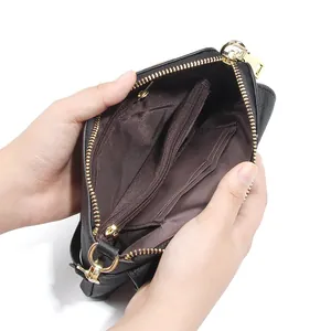 Black leather crossbody phone bag with gold hardware and multiple card slots