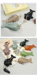 Whale-shaped leather key pouches in various colors with golden hardware and lobster clips