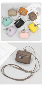 Detailed view of mini leather pouches showing litchi texture and metal hardware