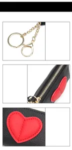 Detail view of leather heart coin purse with golden hardware and lobster clasp hooks
