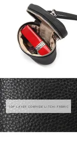 Detailed view of black litchi grain cowhide leather pouch with silver zipper and coins