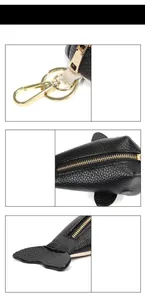 Macro detail of whale-shaped leather key pouch showing lychee texture and gold hardware