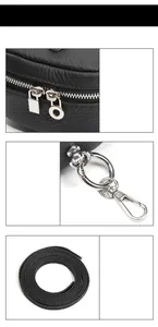 Detail of lychee pattern leather purse with silver metal zippers and detachable strap