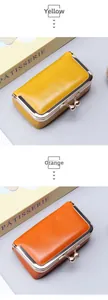 Macro shot of retro leather coin purses in yellow and orange with silver metal clasps