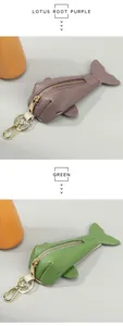 Detail of whale-shaped leather key pouches in lotus root purple and green with gold hardware