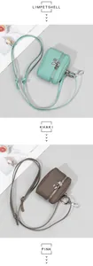 Close-up of pebble leather mini bags with silver zippers and hooks in various colors