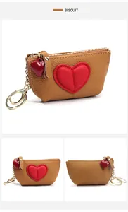 Macro view of biscuit leather heart coin purse with gold zipper and key ring detail