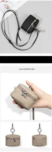 Detailed view of litchi leather mini pouch with silver zipper and detachable neck strap