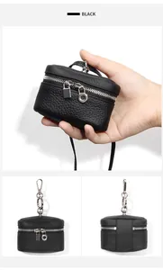 Close-up of black pebble grain leather coin purse with silver metal hardware and chain