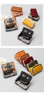 Detailed view of mini vintage clasp pouches with gold hardware and interior leather strap